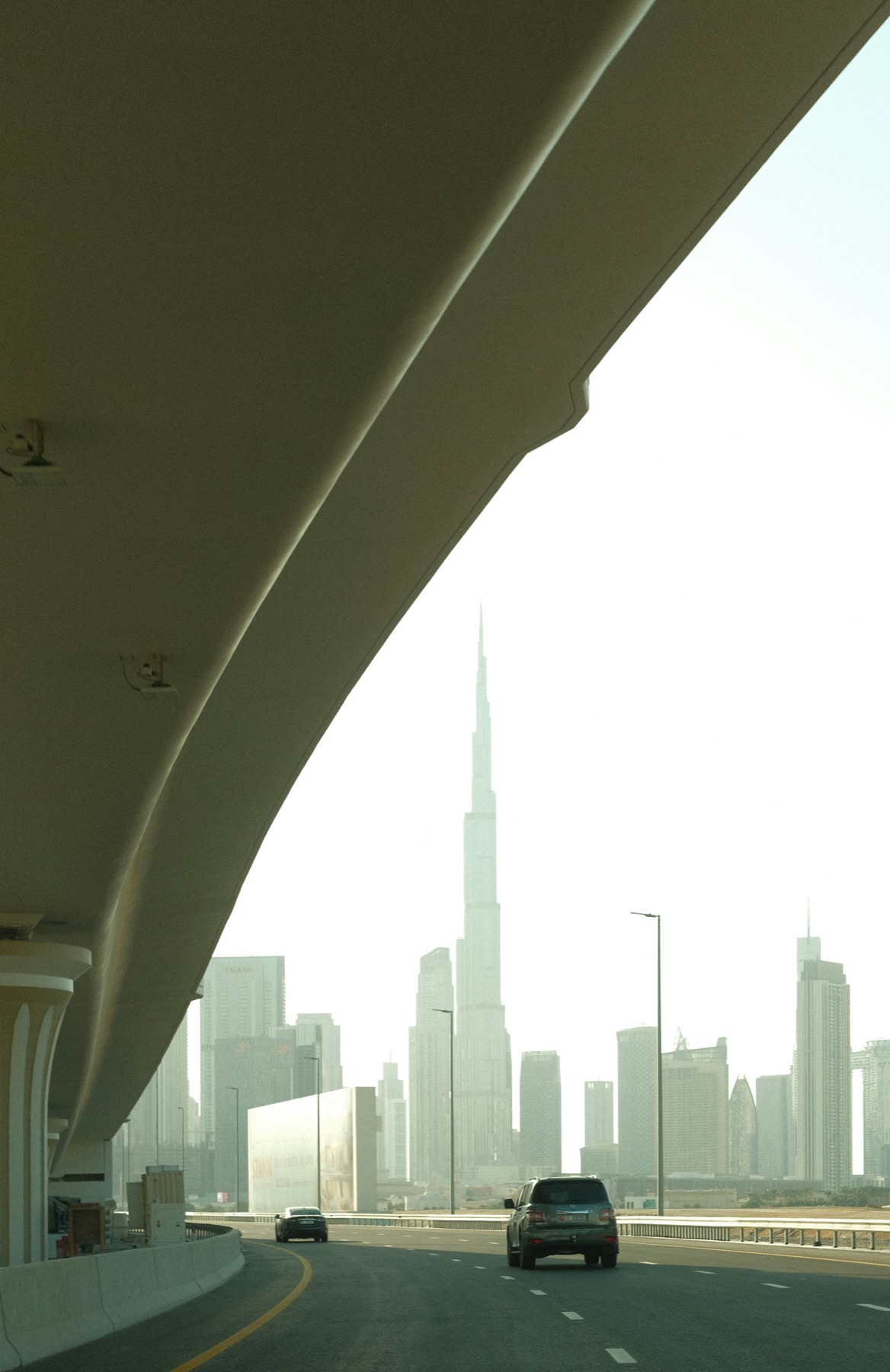 Cars on a Dubai highway with Burj Khalifa in the skyline