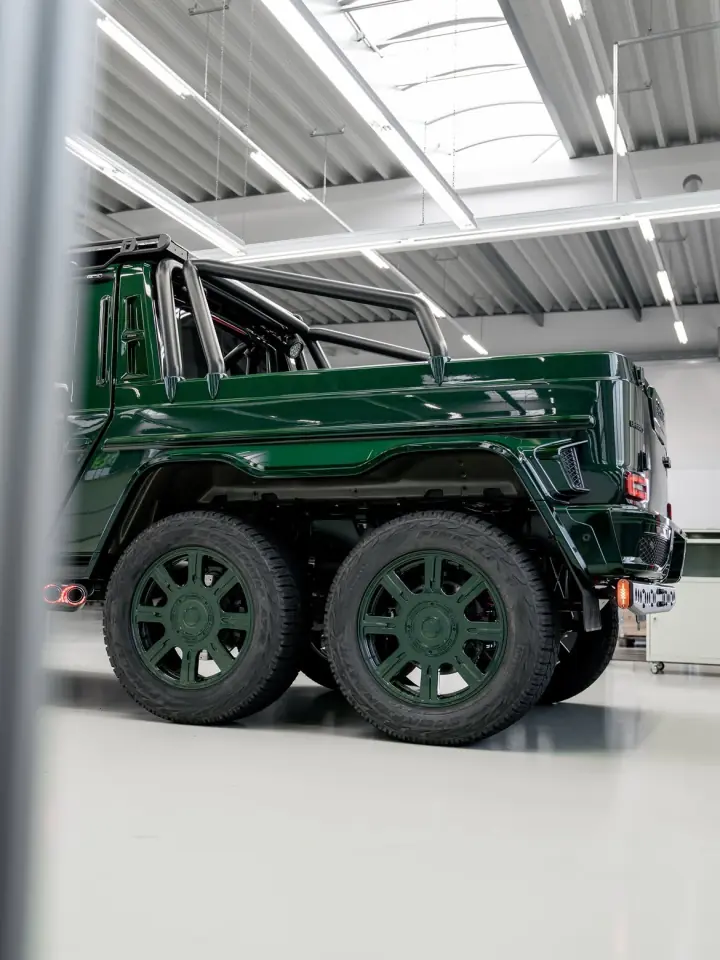 Green Mercedes-Benz G-Class 6x6 in a bright automotive studio
