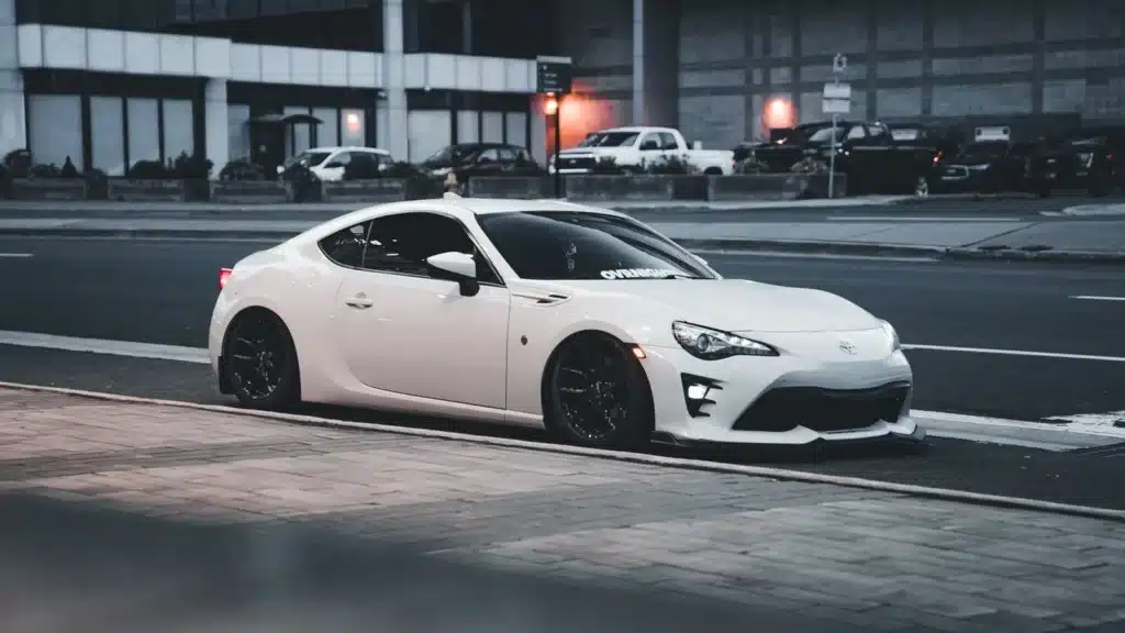 A modern white sports car parked on a city street, showcasing sleek design and urban vibe.