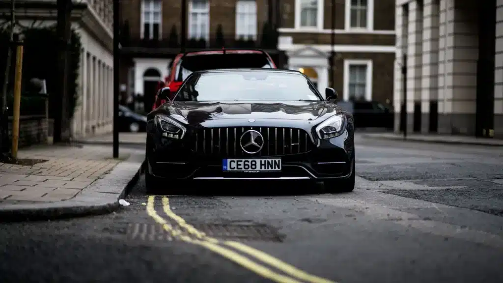 A sleek black Mercedes Benz parked on a London street, showcasing luxury and style.