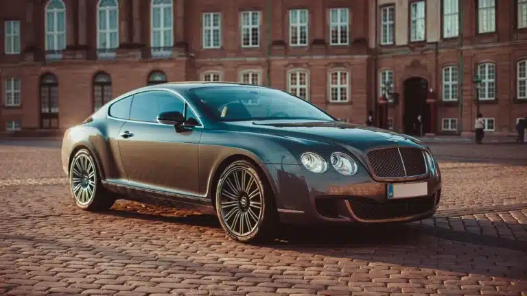 Elegant Bentley Continental GT on cobblestone street in historic Copenhagen during daytime.