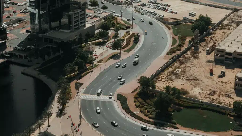 Aerial view of Dubai's roads, buildings, and urban planning during the day.