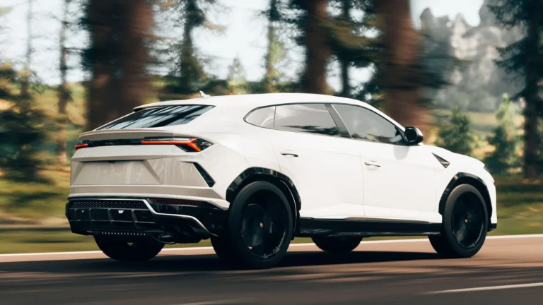 A white luxury SUV driving on a scenic road.